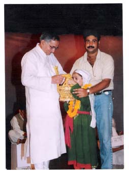 A Student Presenting Kangri to J.N. Koul - Director SOS